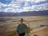 16 Jerome Ryan On Top Of Hill With Tingri And Tingri Plain Behind In 1998 In 1998 Jerome Ryan, with Tingri behind, climbed a nearby hill to help acclimatization.